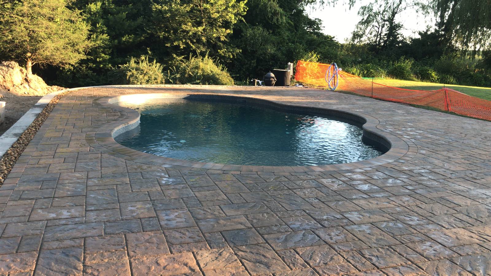 Paver pool deck at golden hour, Massachusetts